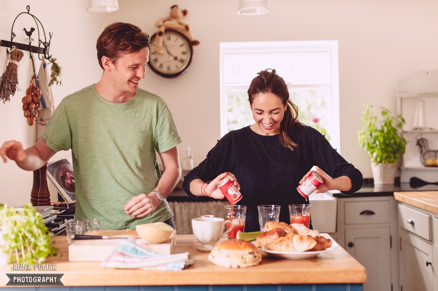 A couple is captured in an engagement shoot while making breakfast together.