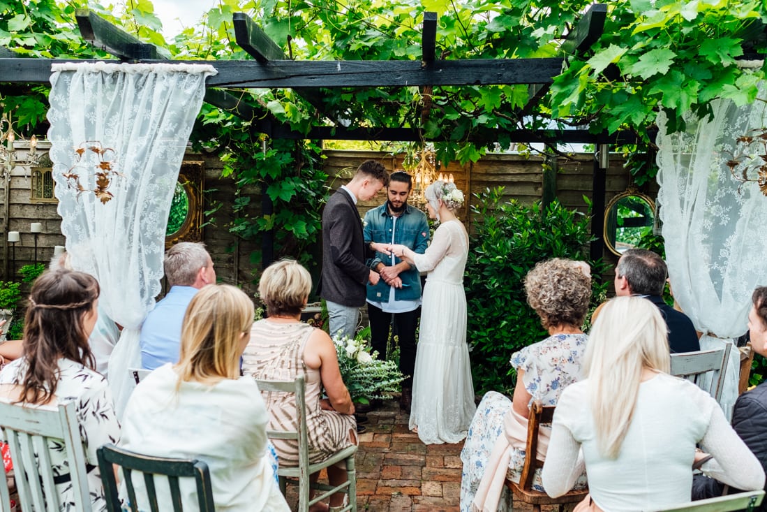 ring exchange during back garden wedding ceremony