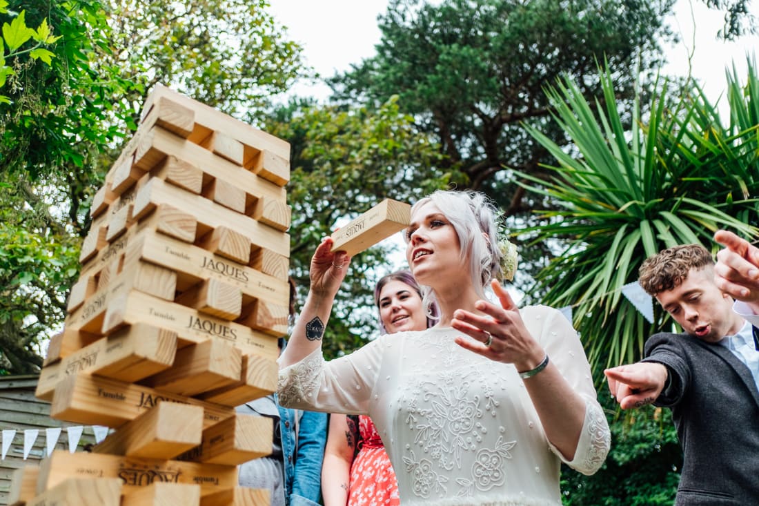 bride playing giant jenga at a back garden wedding in kent