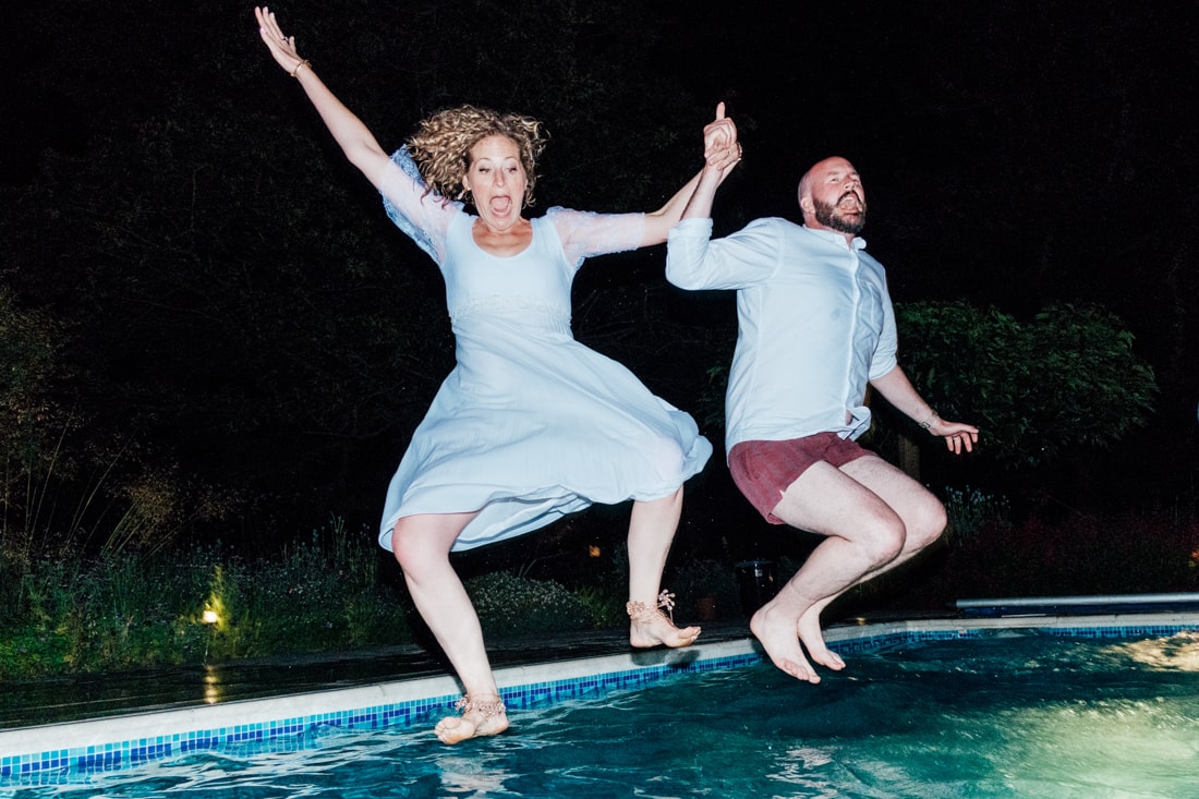 Back garden wedding pool party-94 wedding bride and groom jumping in the pool
