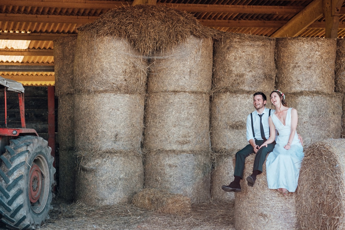 wedding portrait in a barn of hay bales