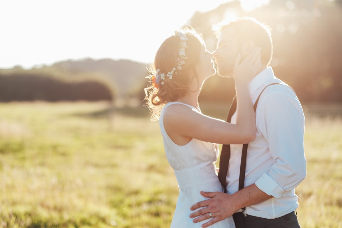 wedding couple in field at sunset