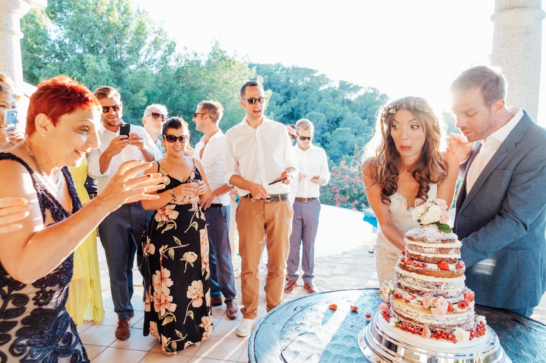 bride cutting cake at ibiza travel wedding in a villa