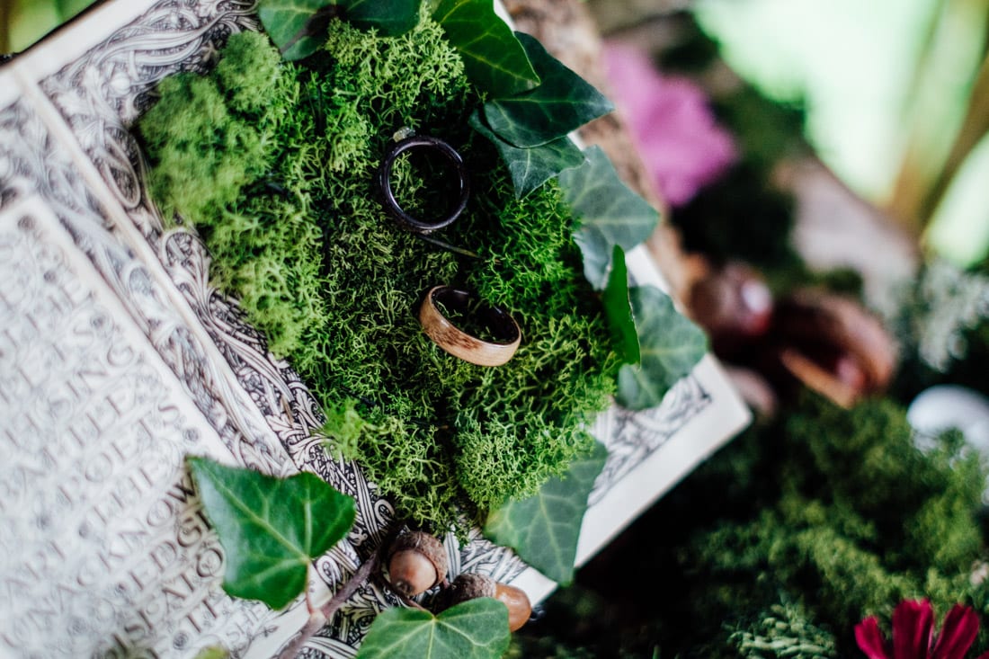 wooden wedding rings on moss