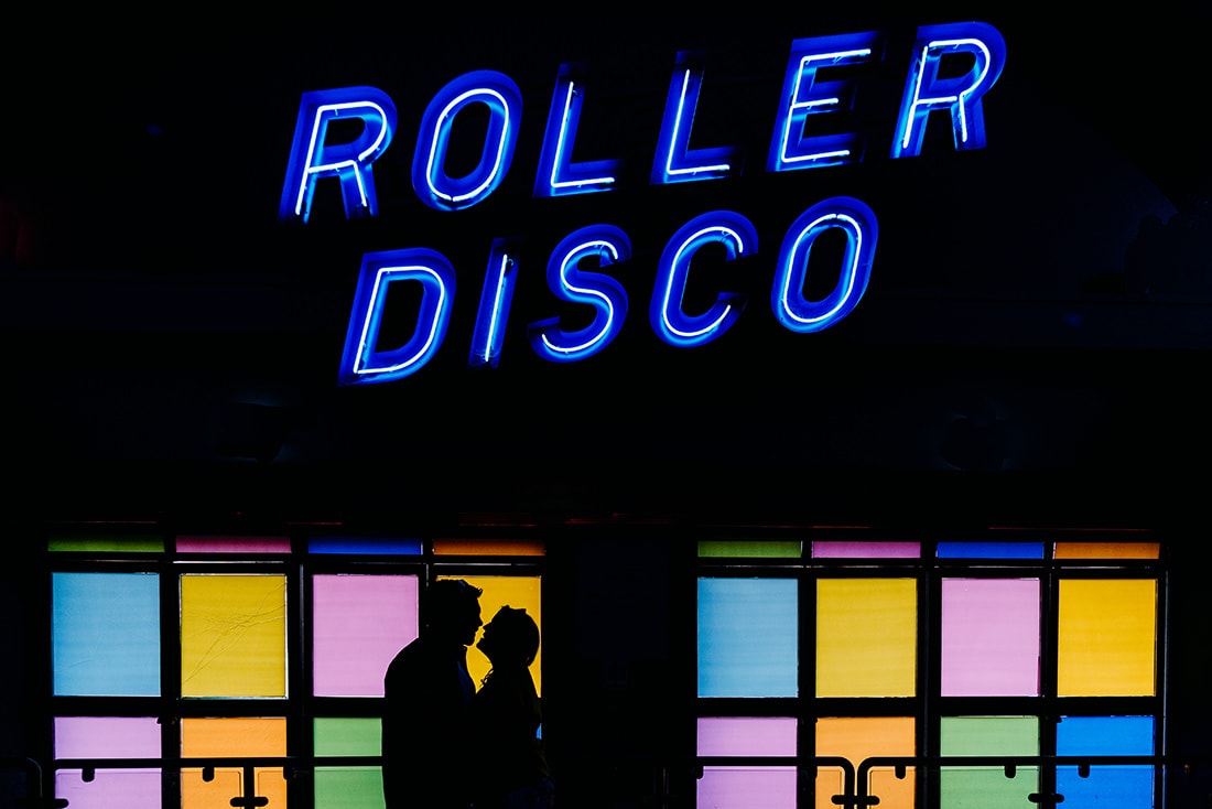 bride and groom kissing at roller rink at dreamland margate kent