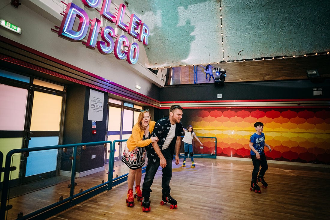 bride and groom skating at roller rink at dreamland margate kent