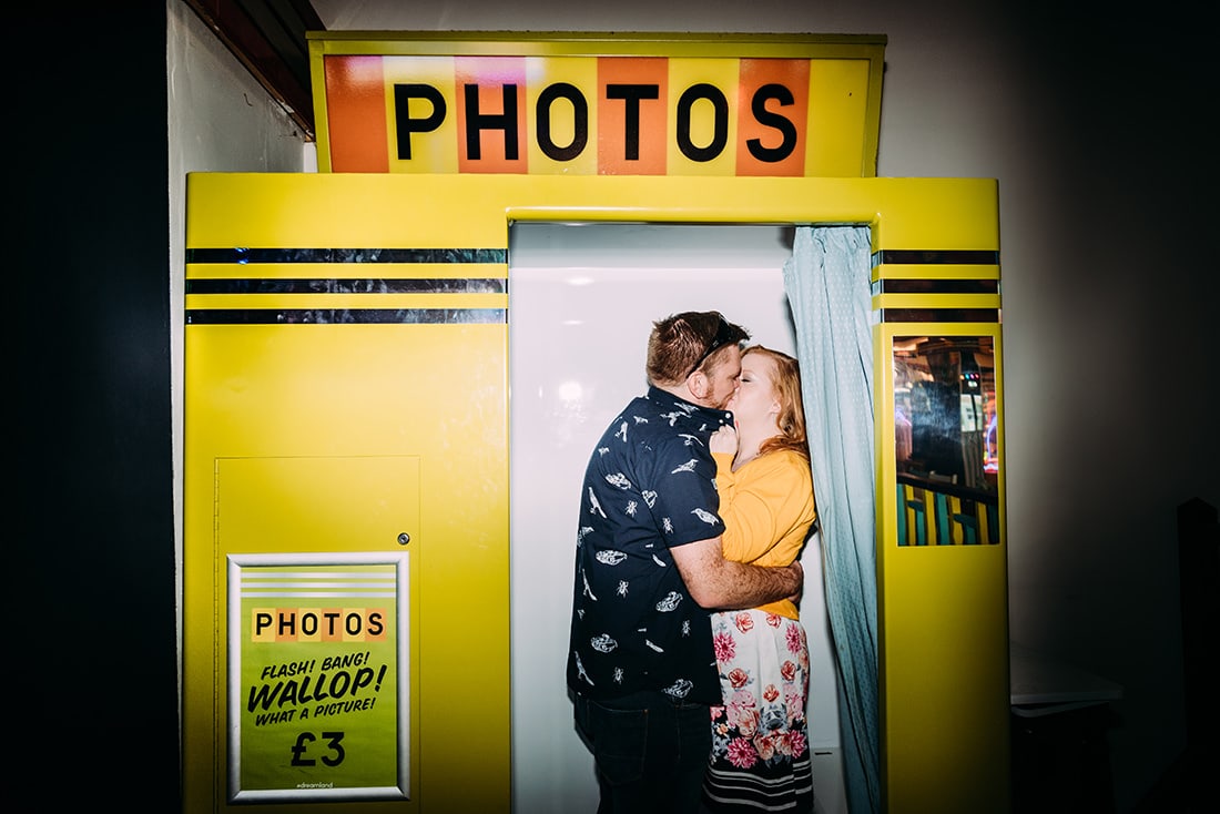 couple kissing in a retro photobooth at dreamland margate kent