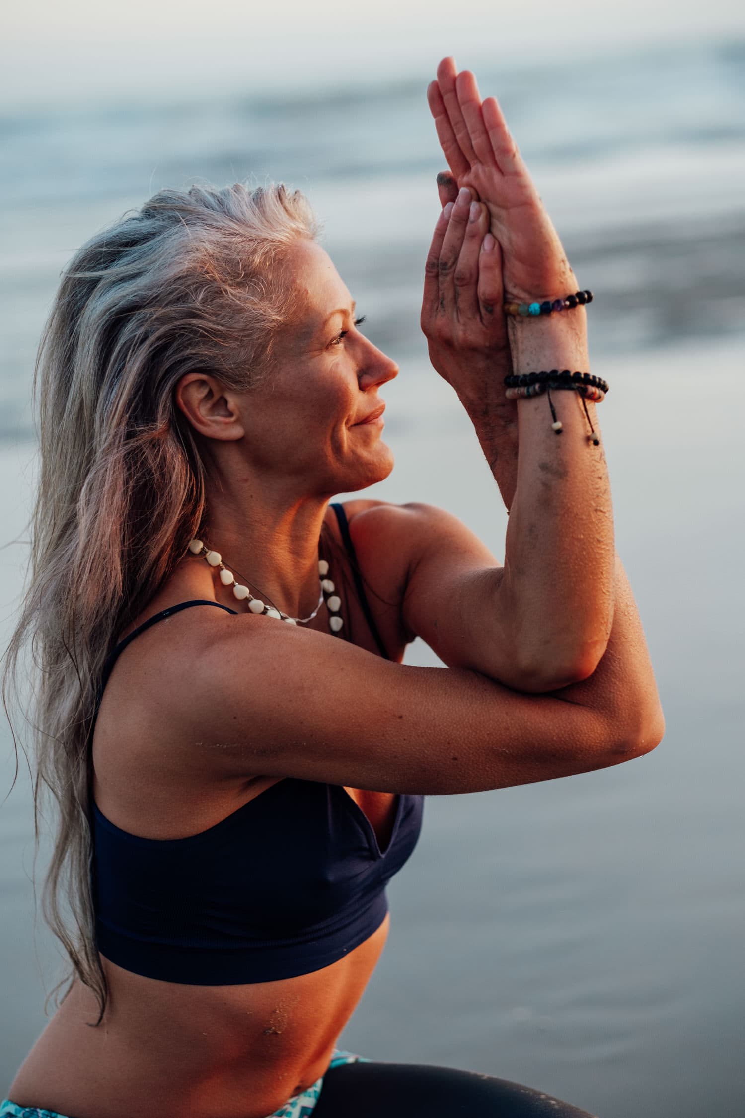yoga pose on the beach for corporate headshot photography in brighton at sunset