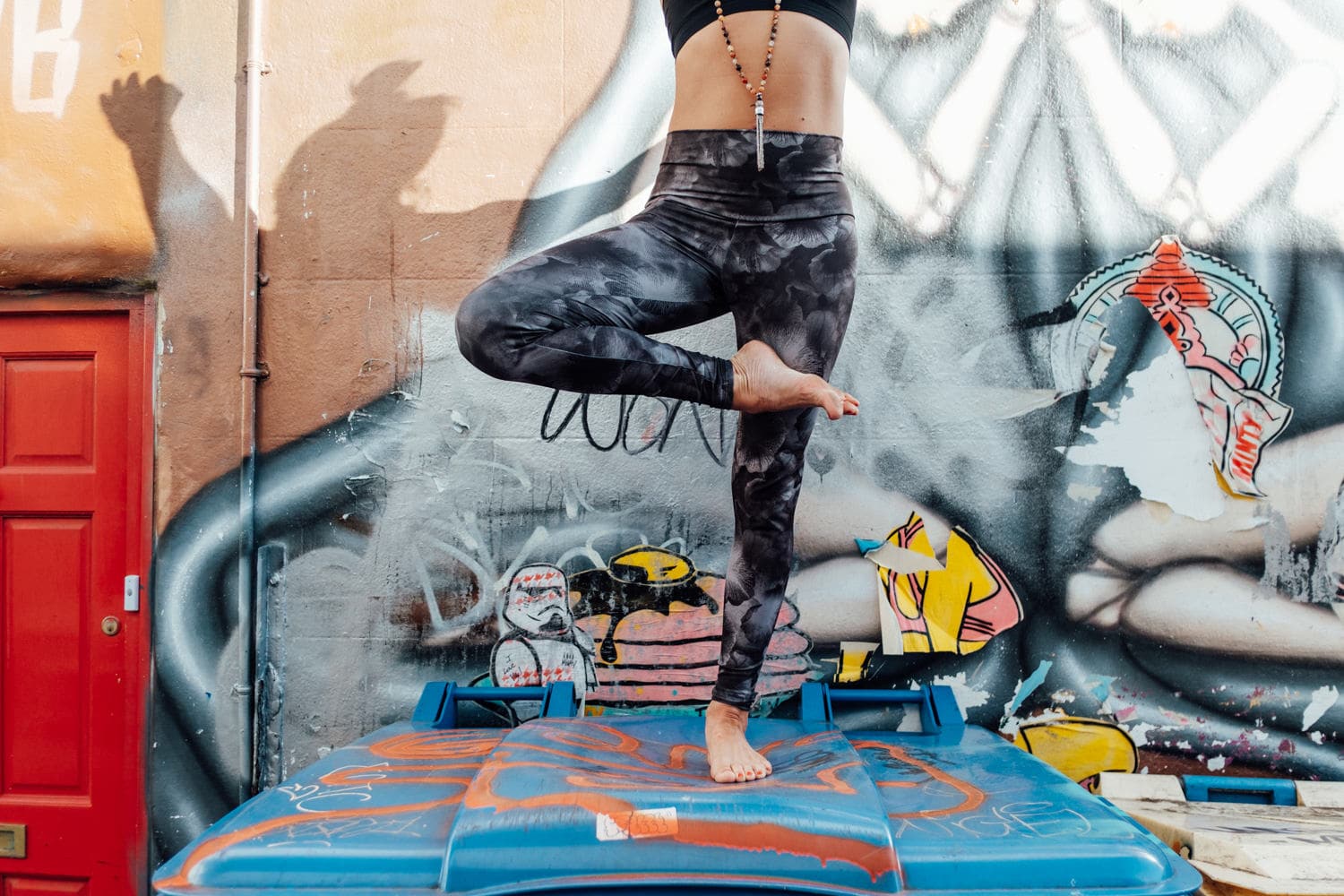 yoga photoshoot for corporate headshot photography in front of brighton graffiti on top of bins