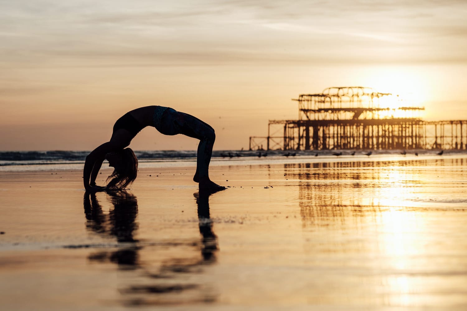 yoga pose on the beach for corporate headshot photography in brighton at sunset