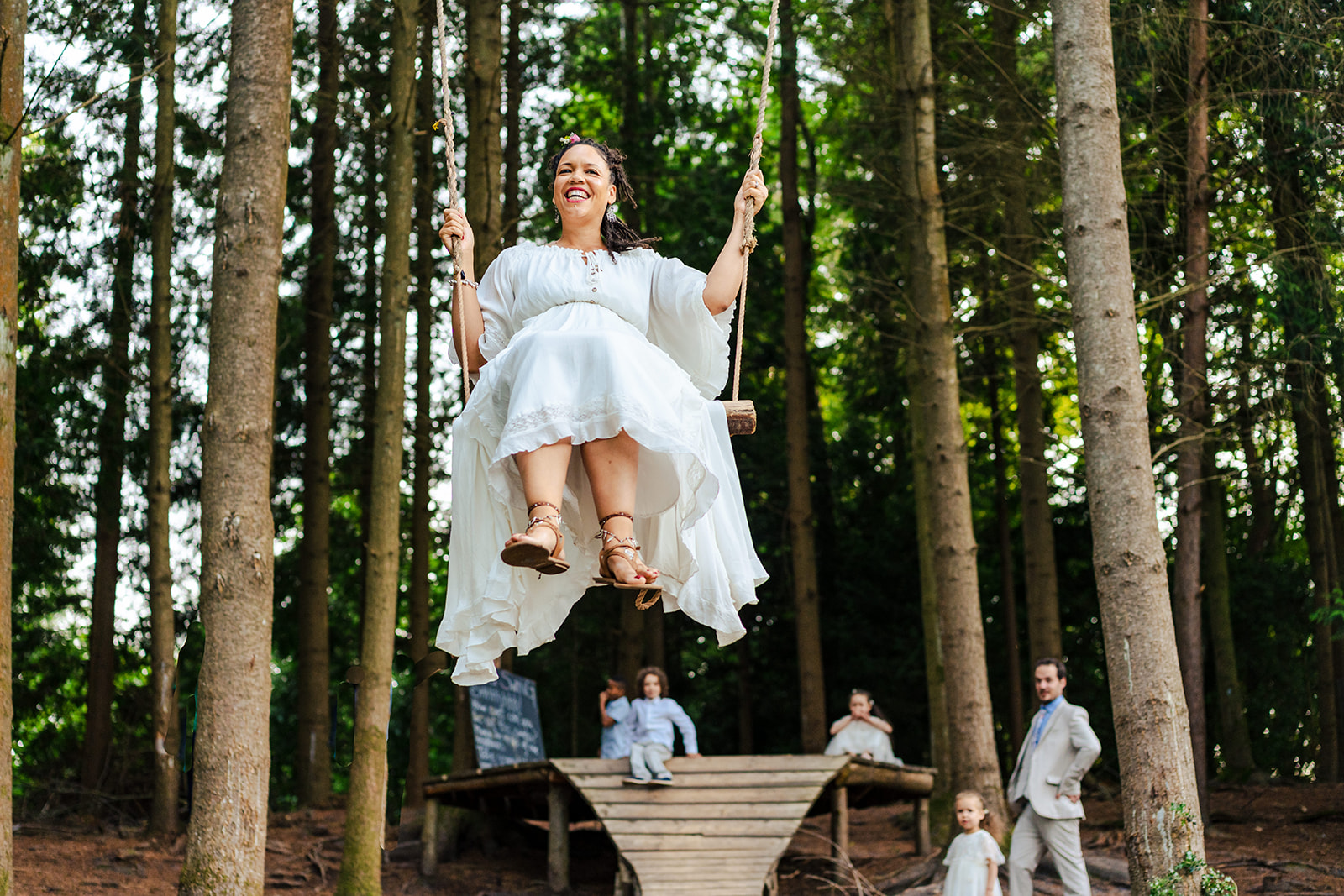 A woman swings in the wilderness.
