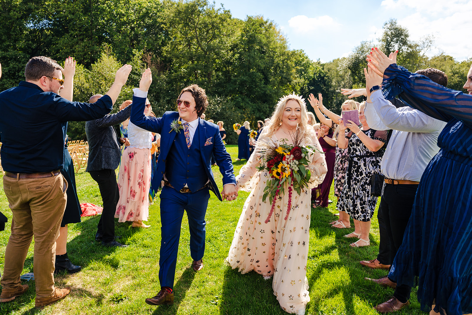 A bride and groom having a zero waste wedding while walking down the aisle.