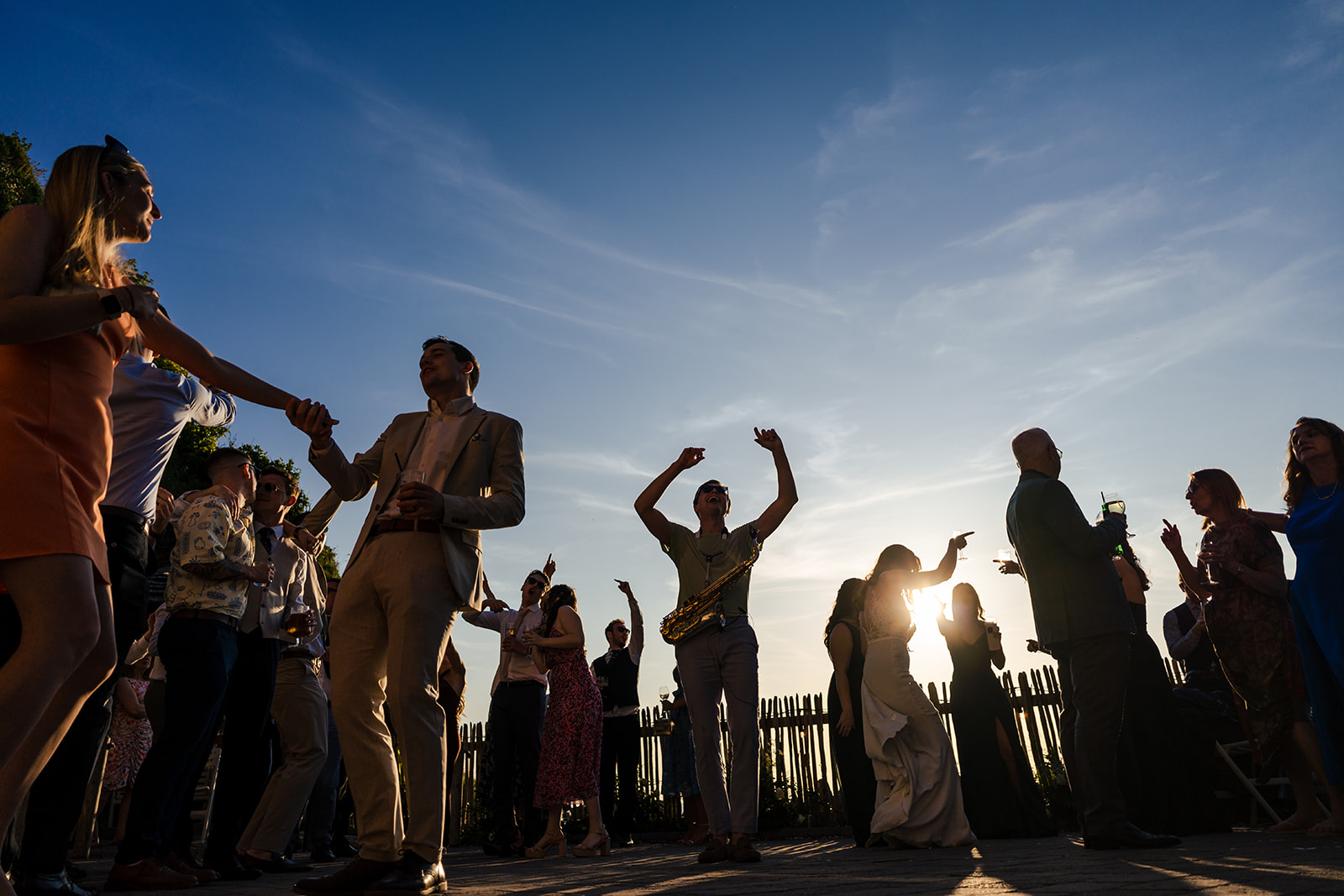A bride and groom are surrounded by confetti at their wedding.